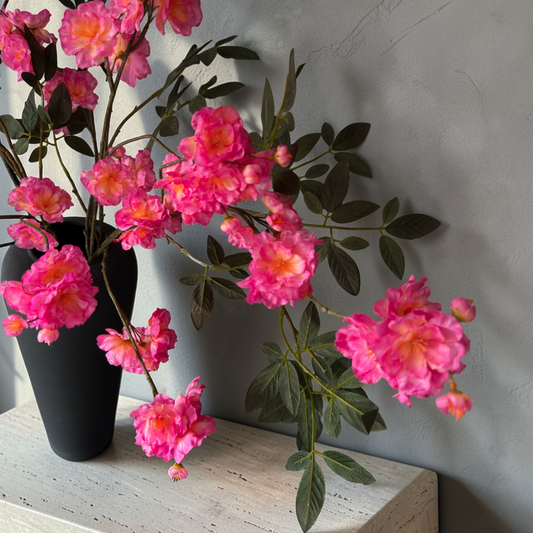 Wild Blossom Bouquet with high-quality silk pink blossoms and natural branches arranged in a tall black vase for elegant home decor and interior styling.