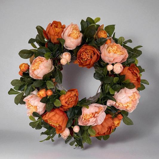 Handmade floral wreath with peach and burnt orange peonies, accented with lush green foliage. Elegant seasonal wreath perfect for front door décor, weddings, or home decoration – a timeless statement piece with romantic autumn tones.