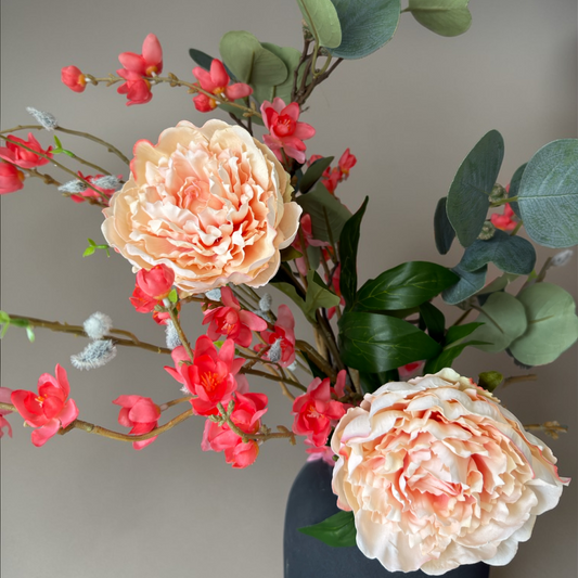 Luxury Peach Bloom silk flower bouquet with peach garden roses, coral blossoms and eucalyptus in a modern black vase for timeless home decor.