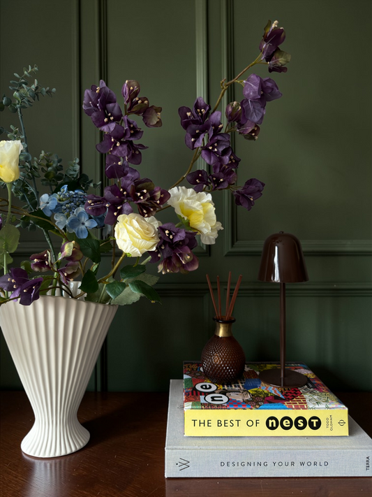 Luxury silk flower bouquet in plum, yellow and blue tones with blossom branches and hydrangea styled in a white vase for timeless home decor.