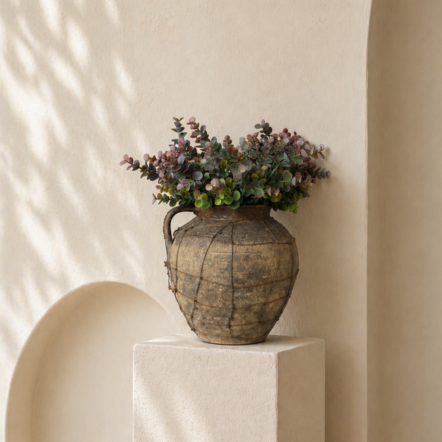 Dusky Eucalyptus Bouquet, a luxury silk eucalyptus bouquet with muted green and soft burgundy tones styled in a rustic earthenware vase