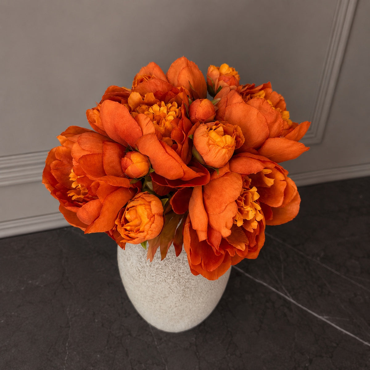 Top view of a full luxury faux peony bouquet in burnt orange and rust tones