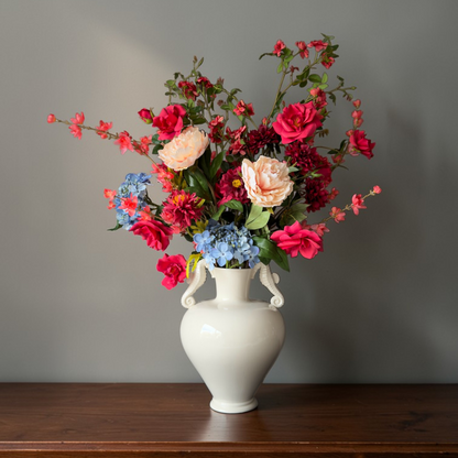 Coral Garden Bouquet with high-quality silk flowers in coral, red, blush and blue tones styled in a white ceramic vase for elegant home decor