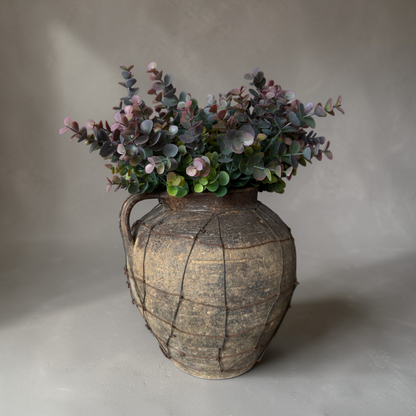 Dusky Eucalyptus Bouquet with high-quality silk eucalyptus stems in muted green and soft burgundy tones styled in a rustic vase for elegant home decor