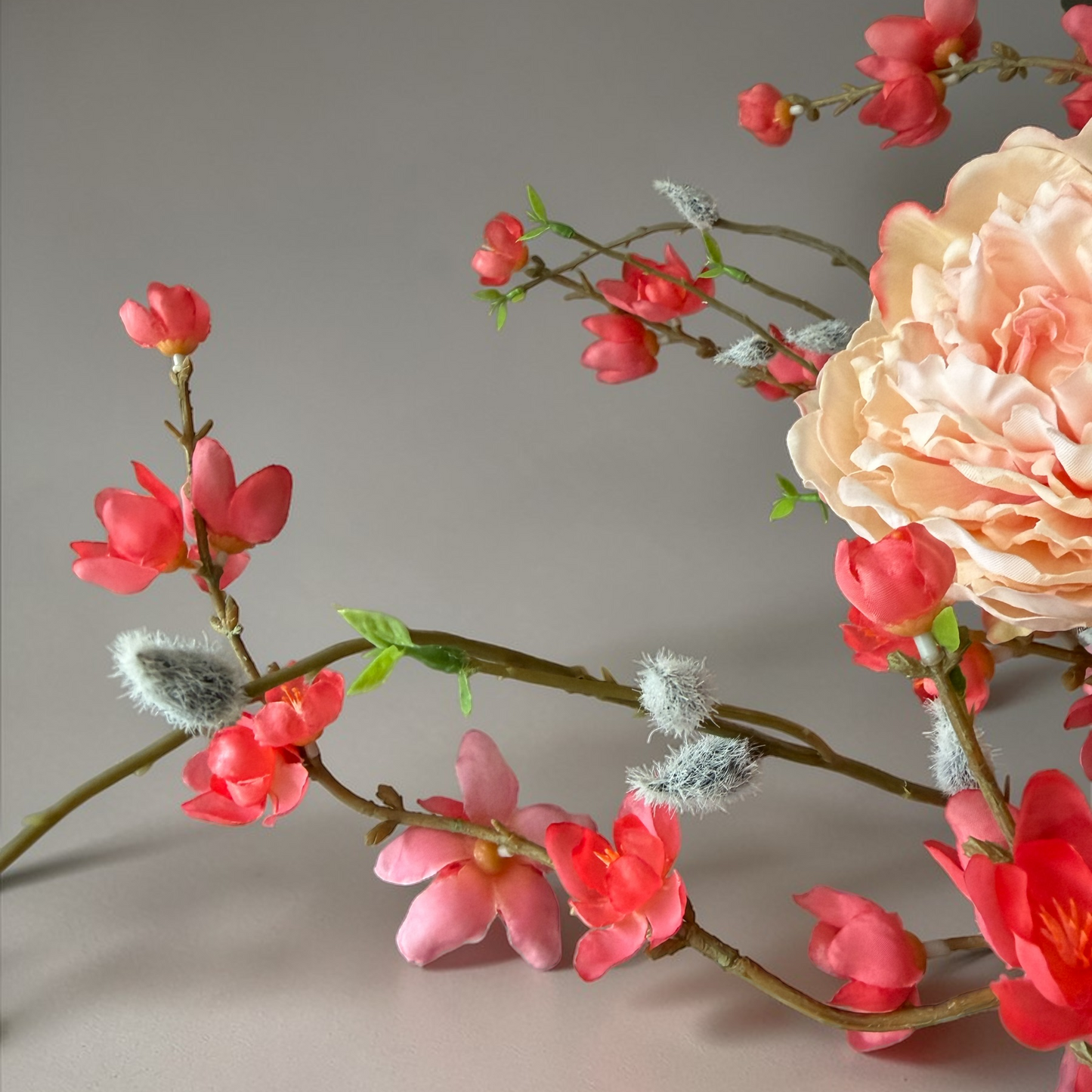 Peach Bloom Bouquet with high-quality silk flowers in peach, coral and soft green tones arranged in a tall black vase for elegant home decor and interior styling.