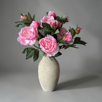 Luxury silk peony bouquet with soft pink peony flowers and realistic green leaves styled in a ceramic vase, elegant artificial flower bouquet for home decor, interior styling, and timeless floral decoration.