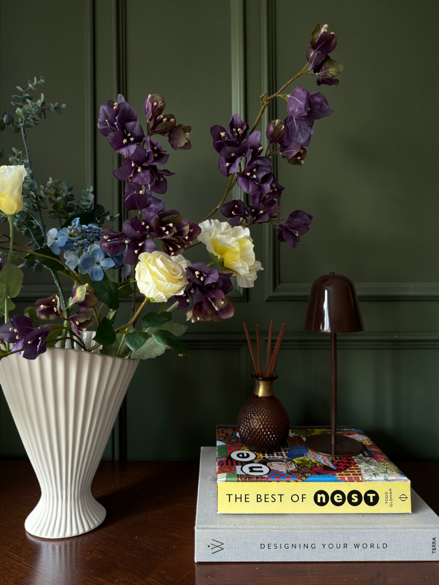 Luxury silk flower bouquet in plum, yellow and blue tones with blossom branches and hydrangea styled in a white vase for timeless home decor.