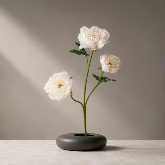 Real touch cream pink peony stem with lifelike petals styled in a sculptural black vase