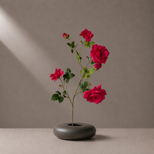 Real touch red rose spray stem with multiple blooms styled in a sculptural black vase